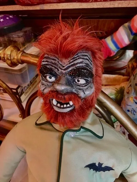 A man with red hair and fake teeth wearing a mask.