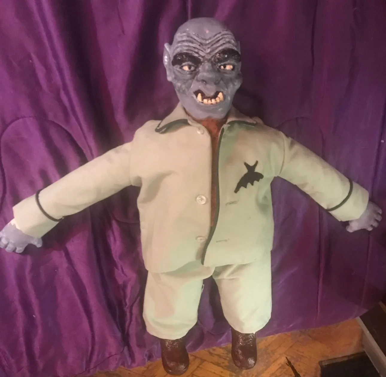 A doll with a face and arms in the shape of a man.