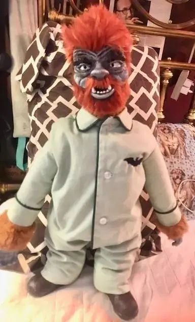 A stuffed animal wearing pajamas and a shirt.