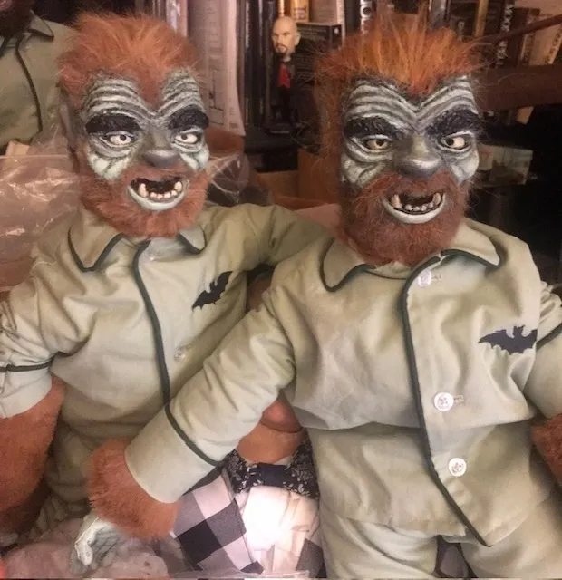 Two stuffed animals with makeup on their faces.