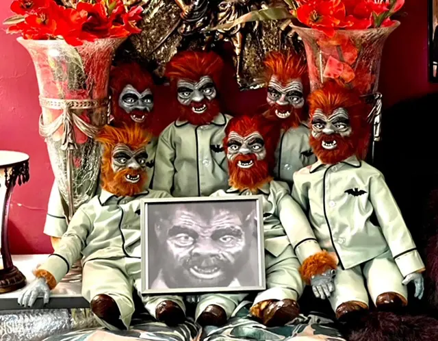 A group of red headed dolls with faces painted to look like they are looking at the picture.